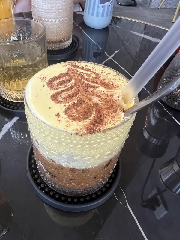 Vietnamese egg coffee, whipped egg dusted with cinnamon over coffee