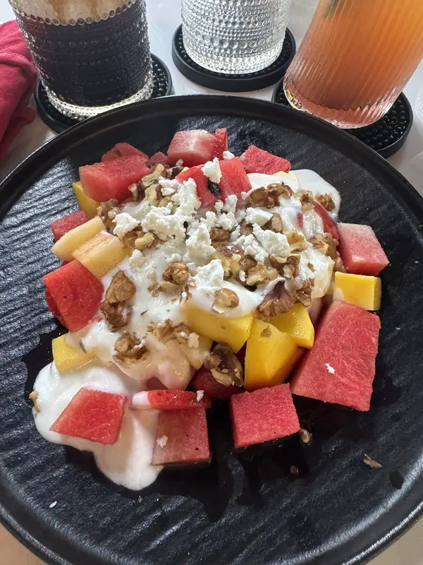 Fruit salad with yogurt, walnut, feta, watermelon and mango